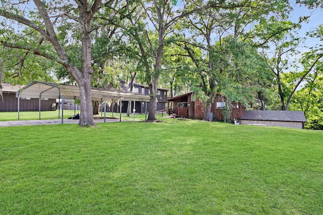 12 Walker Trl, Huntsville, TX 77320 - view of grassy yard with a detached carport, driveway, and an outdoor structure