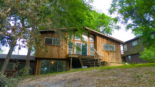 12 Walker Trl, Huntsville, TX 77320 - view of front of home with a wooden deck and board and batten siding