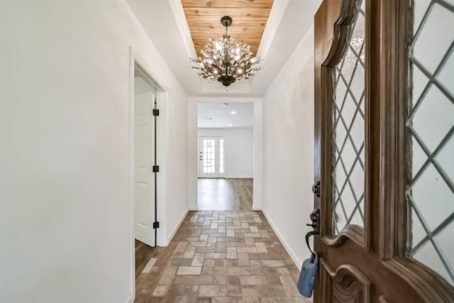 2742 Triway Ln, Houston, TX 77043 - hallway with a chandelier, baseboards, brick floors, and wooden ceiling