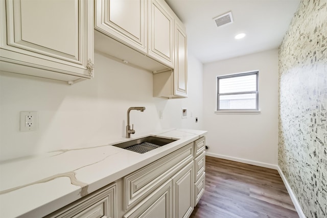 2742 Triway Ln, Houston, TX 77043 - kitchen featuring a sink, light stone countertops, dark wood-type flooring, and baseboards