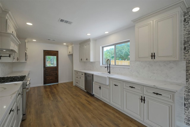 2742 Triway Ln, Houston, TX 77043 - kitchen with a sink, appliances with stainless steel finishes, decorative backsplash, dark wood-style flooring, and recessed lighting