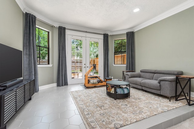 9410 Windrush Dr, Spring, TX 77379 - living room featuring healthy amount of natural light, a textured ceiling, french doors, ornamental molding, and tile patterned flooring