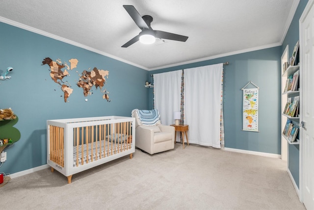 9410 Windrush Dr, Spring, TX 77379 - carpeted bedroom with a crib, ornamental molding, baseboards, and a ceiling fan