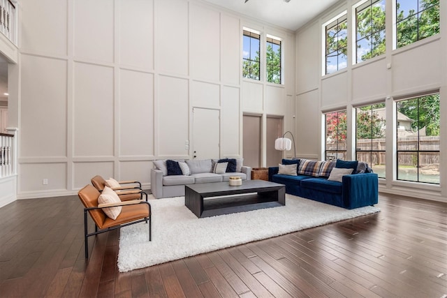 9410 Windrush Dr, Spring, TX 77379 - living room featuring a decorative wall, a high ceiling, dark wood finished floors, and ornamental molding
