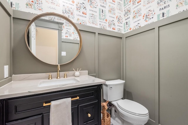 9410 Windrush Dr, Spring, TX 77379 - bathroom featuring toilet, vanity, and a decorative wall