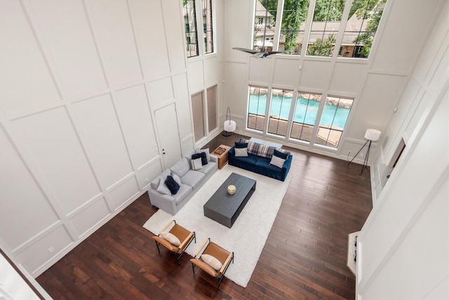9410 Windrush Dr, Spring, TX 77379 - living area featuring a decorative wall, plenty of natural light, and dark wood-type flooring