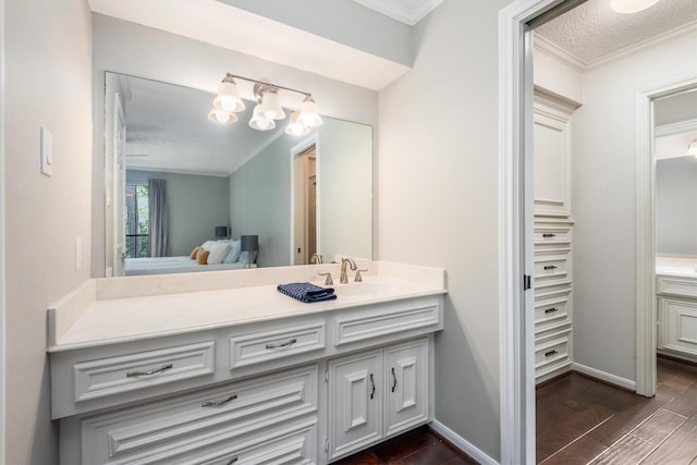 9410 Windrush Dr, Spring, TX 77379 - bathroom with vanity, crown molding, wood finished floors, and ensuite bath