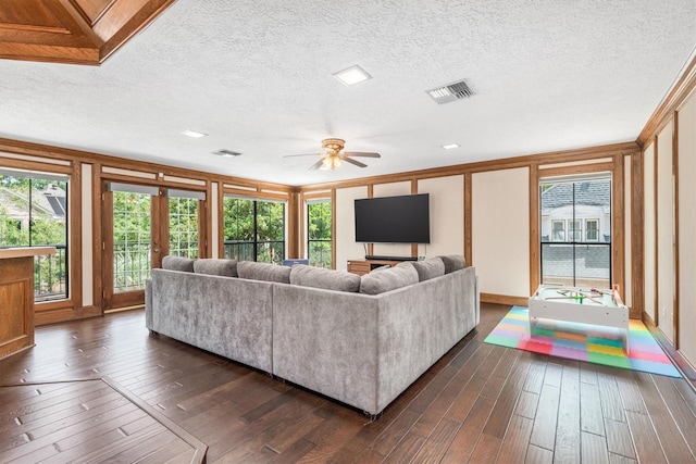 9410 Windrush Dr, Spring, TX 77379 - living room featuring healthy amount of natural light, dark wood-style flooring, ceiling fan, a textured ceiling, and french doors