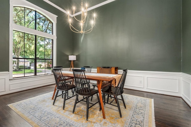 9410 Windrush Dr, Spring, TX 77379 - dining space with a chandelier, wainscoting, wood finished floors, and a decorative wall