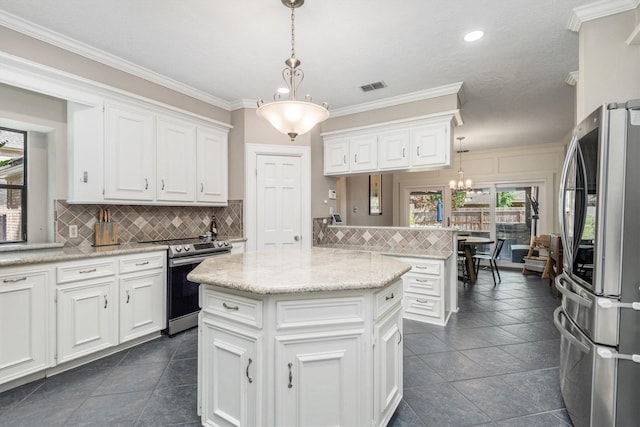9410 Windrush Dr, Spring, TX 77379 - kitchen featuring stainless steel appliances, white cabinets, tasteful backsplash, a chandelier, and decorative light fixtures