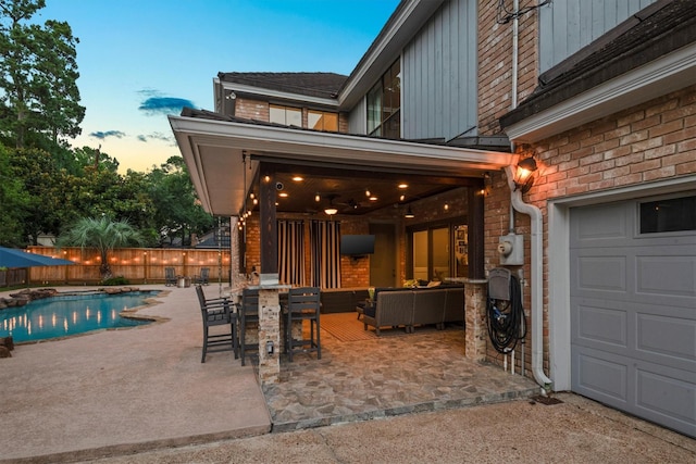 9410 Windrush Dr, Spring, TX 77379 - view of patio / terrace featuring a garage and an outdoor living space