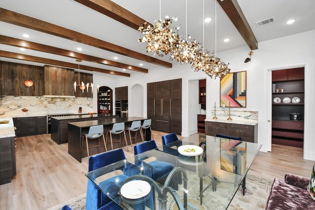 7153 Fm 1458th Rd, Sealy, TX 77474 - dining space with arched walkways, a chandelier, beam ceiling, light wood-style flooring, and recessed lighting
