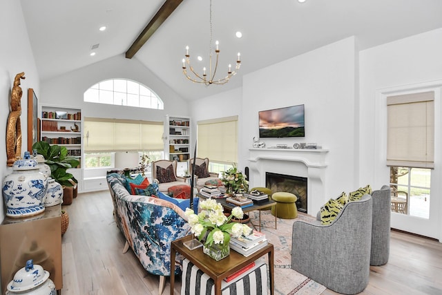 7153 Fm 1458th Rd, Sealy, TX 77474 - living room featuring wood finished floors, beamed ceiling, a chandelier, a glass covered fireplace, and high vaulted ceiling