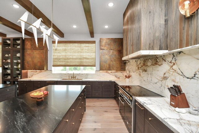 7153 Fm 1458th Rd, Sealy, TX 77474 - kitchen featuring electric range, beam ceiling, a sink, light wood-style flooring, and backsplash