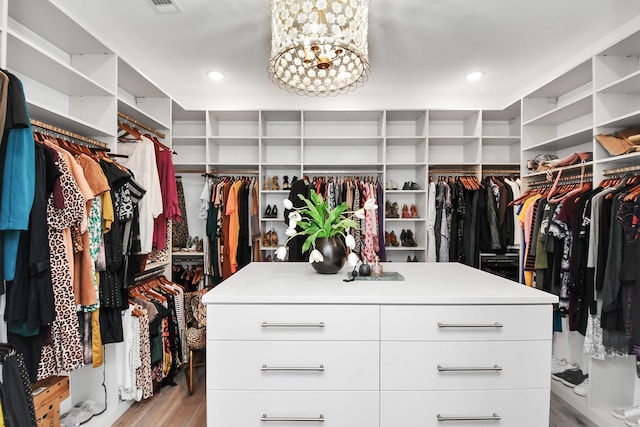 7153 Fm 1458th Rd, Sealy, TX 77474 - walk in closet featuring wood finished floors and a chandelier
