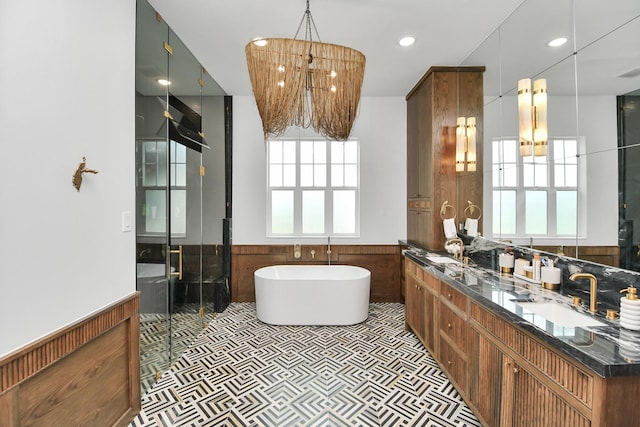 7153 Fm 1458th Rd, Sealy, TX 77474 - full bath featuring wainscoting, a freestanding bath, double vanity, a chandelier, and a stall shower