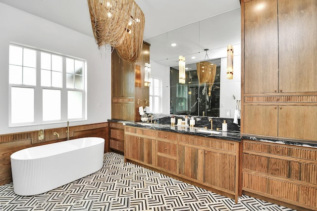 7153 Fm 1458th Rd, Sealy, TX 77474 - bathroom with a shower stall, a soaking tub, vanity, wainscoting, and recessed lighting