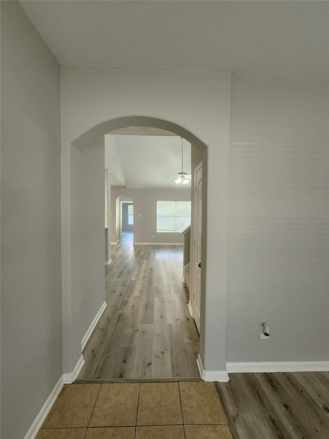 2623 Sable Ridge Ln, Katy, TX 77494 - hallway with arched walkways, wood finished floors, and baseboards