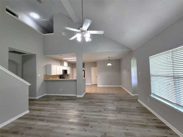 2623 Sable Ridge Ln, Katy, TX 77494 - unfurnished living room with ceiling fan, light wood-type flooring, baseboards, and high vaulted ceiling