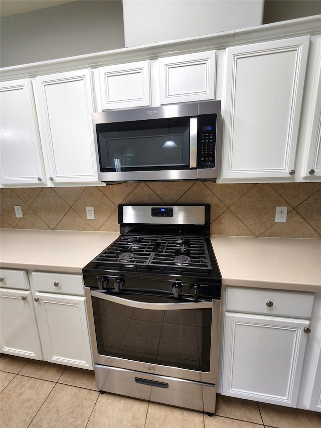2623 Sable Ridge Ln, Katy, TX 77494 - kitchen featuring appliances with stainless steel finishes, white cabinetry, light countertops, and decorative backsplash