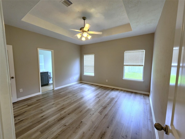 2623 Sable Ridge Ln, Katy, TX 77494 - unfurnished room featuring a raised ceiling, ceiling fan, light wood-style floors, and baseboards