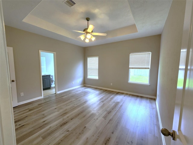 2623 Sable Ridge Ln, Katy, TX 77494 - spare room with a tray ceiling, ceiling fan, and light wood-style floors