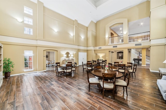 2815 Kings Crossing Dr Unit 106, Houston, TX 77345 - dining area with a towering ceiling, wood finished floors, arched walkways, and baseboards