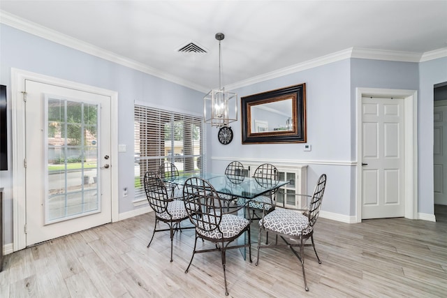2815 Kings Crossing Dr Unit 106, Houston, TX 77345 - dining room with light wood-type flooring, crown molding, baseboards, and a chandelier