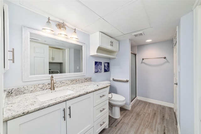 2815 Kings Crossing Dr Unit 106, Houston, TX 77345 - full bathroom with toilet, vanity, wood finished floors, a stall shower, and baseboards