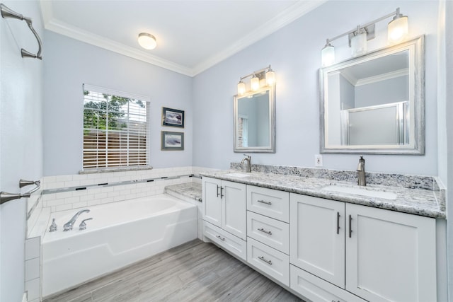 2815 Kings Crossing Dr Unit 106, Houston, TX 77345 - full bath featuring double vanity, ornamental molding, a garden tub, wood finished floors, and a shower with shower door