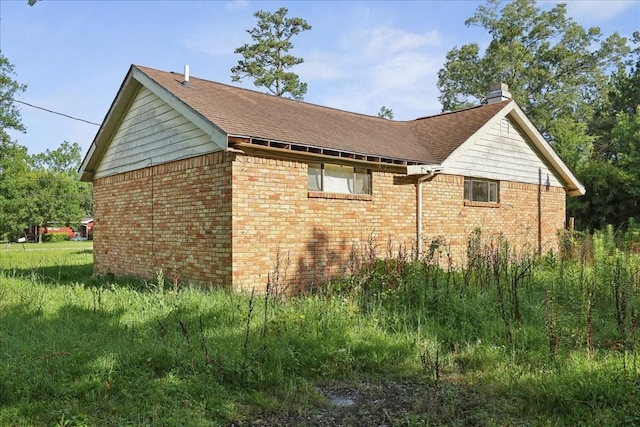 2630 35th St, Pinehurst, TX 77630 - view of property exterior featuring brick siding, a chimney, and a shingled roof