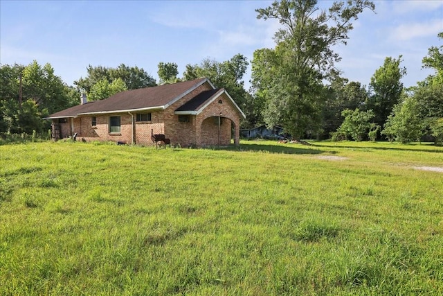 2630 35th St, Pinehurst, TX 77630 - view of property exterior with brick siding and a yard