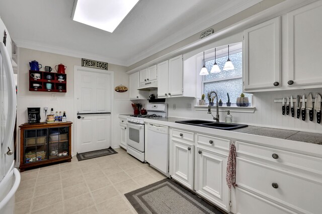 7615 Theisswood Rd, Spring, TX 77379 - kitchen with white appliances, white cabinets, crown molding, under cabinet range hood, and light countertops