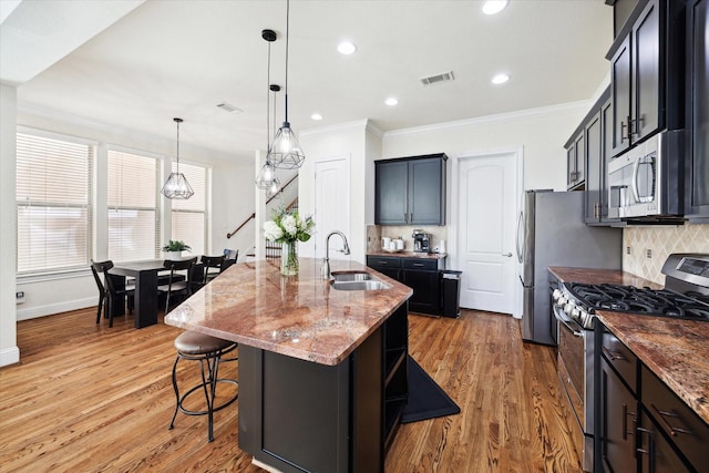 2619 Shady Woods Ln, Houston, TX 77008 - kitchen featuring appliances with stainless steel finishes, a sink, light stone countertops, crown molding, and decorative backsplash
