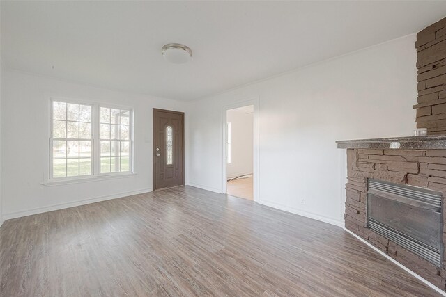 607 Speed St, Wharton, TX 77488 - unfurnished living room with a fireplace, wood finished floors, and baseboards