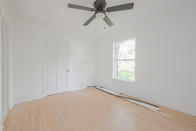 607 Speed St, Wharton, TX 77488 - empty room with attic access, a baseboard heating unit, wood finished floors, and ceiling fan