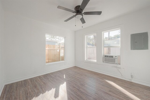607 Speed St, Wharton, TX 77488 - unfurnished room with electric panel, baseboards, wood finished floors, and ceiling fan