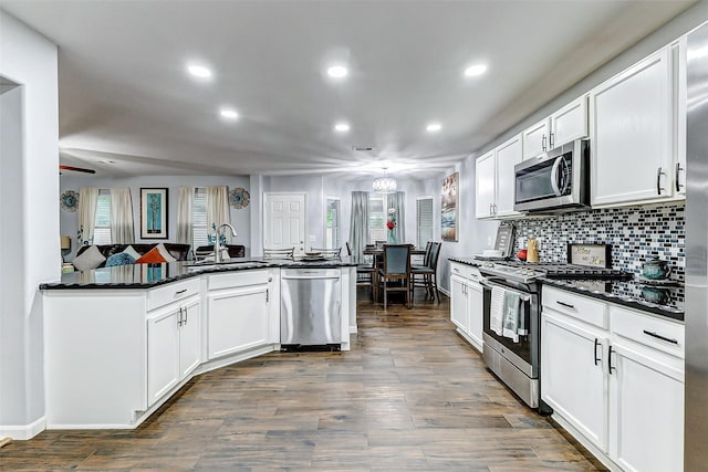 14203 Coveney Dr, Houston, TX 77090 - kitchen with stainless steel appliances, a sink, dark countertops, recessed lighting, and decorative backsplash