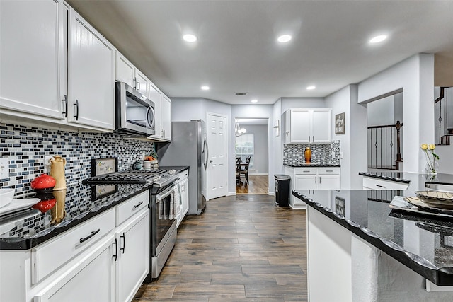 14203 Coveney Dr, Houston, TX 77090 - kitchen featuring stainless steel appliances, dark wood-style flooring, tasteful backsplash, white cabinetry, and recessed lighting