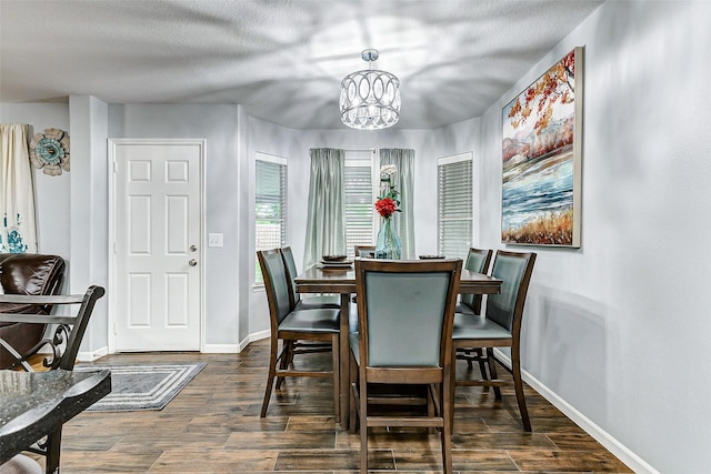 14203 Coveney Dr, Houston, TX 77090 - dining room with baseboards, dark wood finished floors, a chandelier, and a textured ceiling