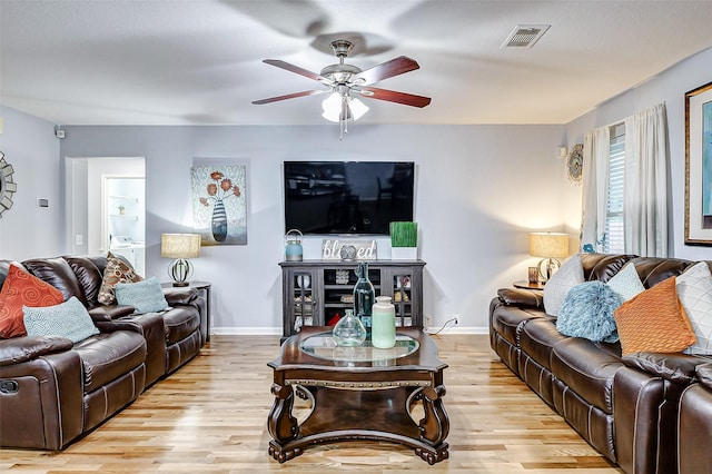 14203 Coveney Dr, Houston, TX 77090 - living room with wood finished floors, ceiling fan, and baseboards