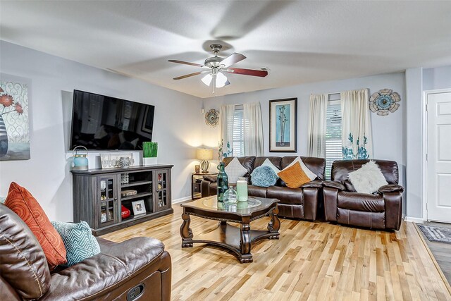 14203 Coveney Dr, Houston, TX 77090 - living area featuring a ceiling fan, wood finished floors, and baseboards
