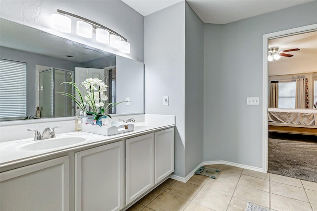 14203 Coveney Dr, Houston, TX 77090 - full bath with ensuite bathroom, double vanity, tile patterned flooring, a ceiling fan, and a shower with shower door