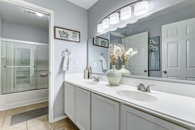 14203 Coveney Dr, Houston, TX 77090 - bathroom with double vanity, tile patterned flooring, and combined bath / shower with glass door