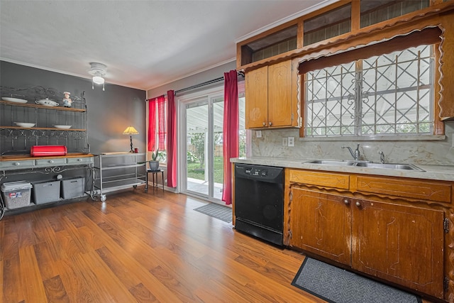 220 Palmyra St, Houston, TX 77022 - kitchen with dishwasher, a sink, wood finished floors, and decorative backsplash