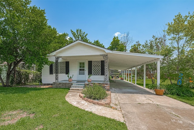 220 Palmyra St, Houston, TX 77022 - view of front of property with driveway, a front lawn, covered porch, and an attached carport