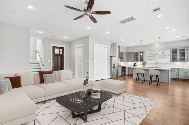 334 Yale Oaks Ln, Houston, TX 77091 - living area with light wood-style floors, recessed lighting, a ceiling fan, and stairway