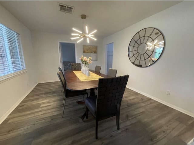 5474 Imogene St, Houston, TX 77096 - dining room with a chandelier, dark wood-type flooring, and baseboards