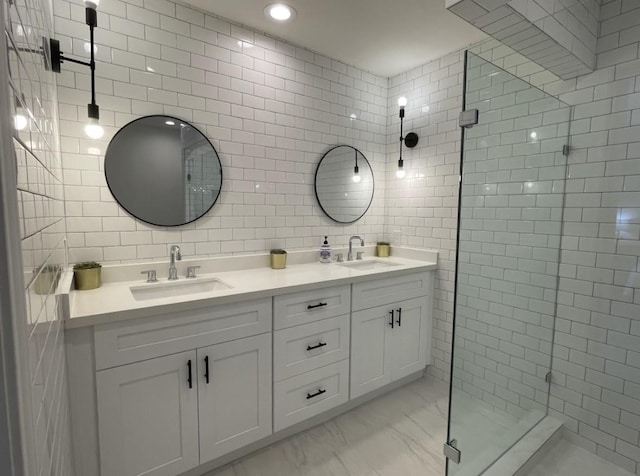 5474 Imogene St, Houston, TX 77096 - full bath with tile walls, double vanity, a stall shower, marble look tiles, and recessed lighting