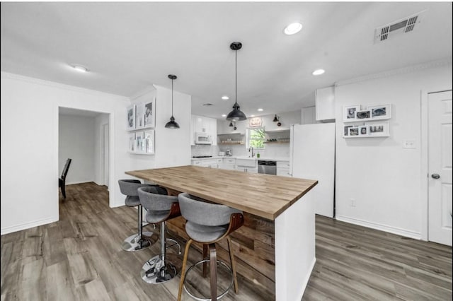 5474 Imogene St, Houston, TX 77096 - kitchen with white appliances, wooden counters, open shelves, white cabinetry, and a sink